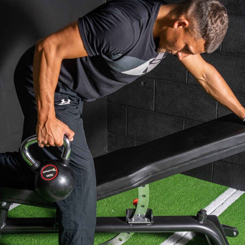 Gym Gear Rubber Kettlebells man doing a single arm bent over row