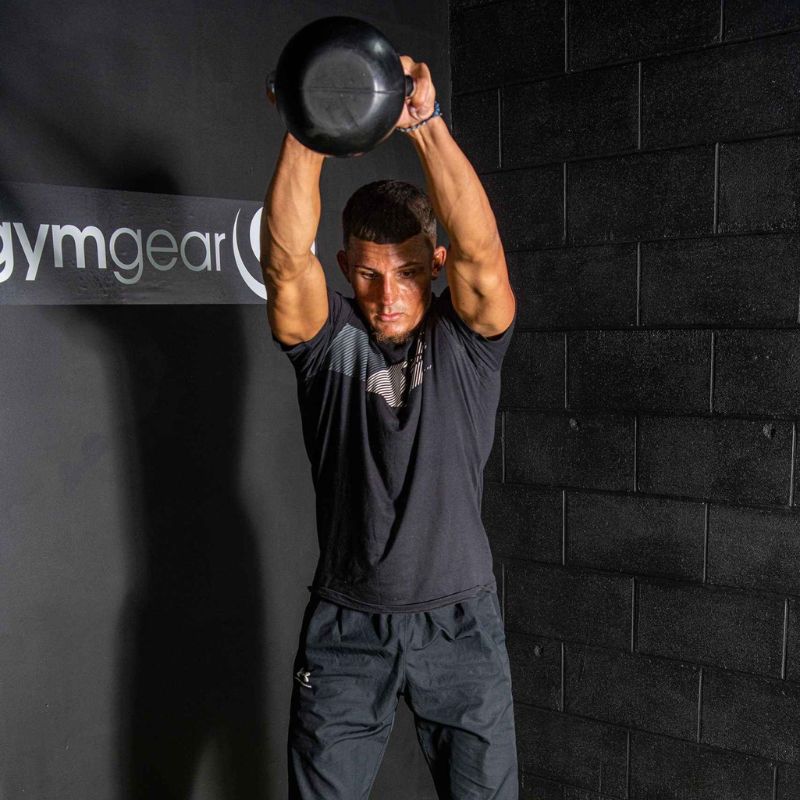 Gym Gear Rubber Kettlebells man doing an american kettle bell swing